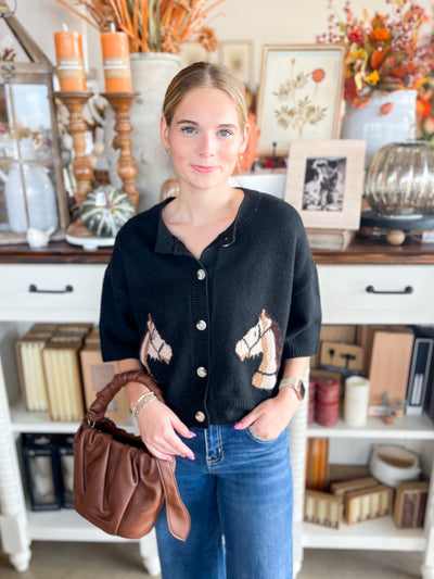 slightly cropped black button cardigan with horses on each side 