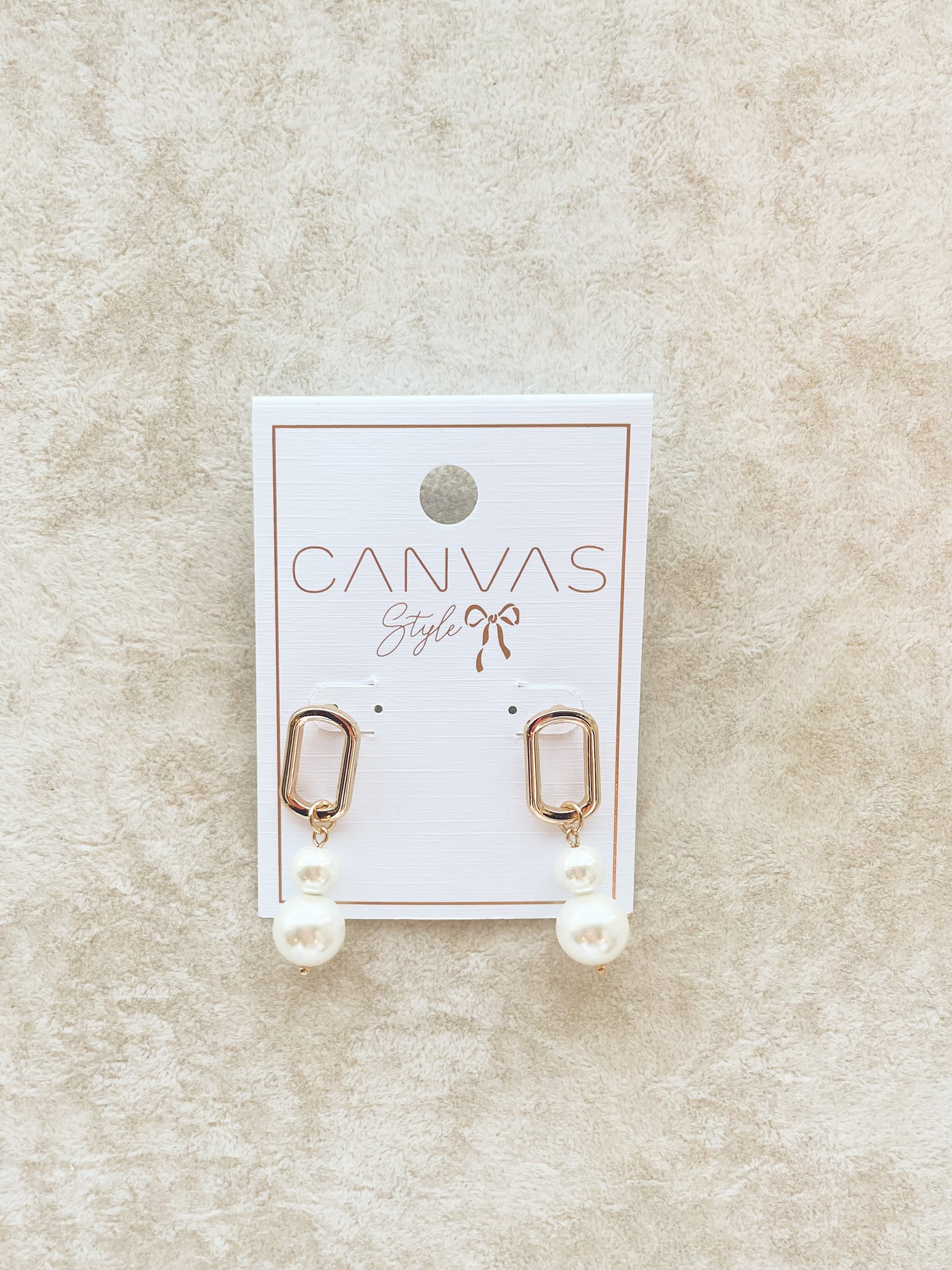 pair of gold earrings with a double pearl drop style 
