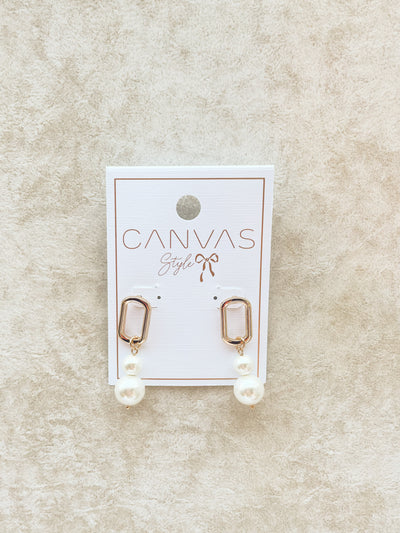 pair of gold earrings with a double pearl drop style 
