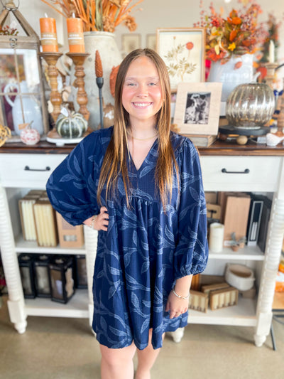 navy blue long sleeve dress with textured flower detail all throughout 