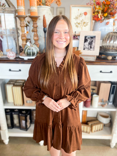stunning brown corduroy dress with ruffle neckline, sleeves, and hem 