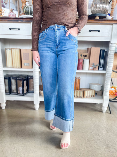medium wash wide leg denim blue jeans with thick cuff and belt loops and pockets 