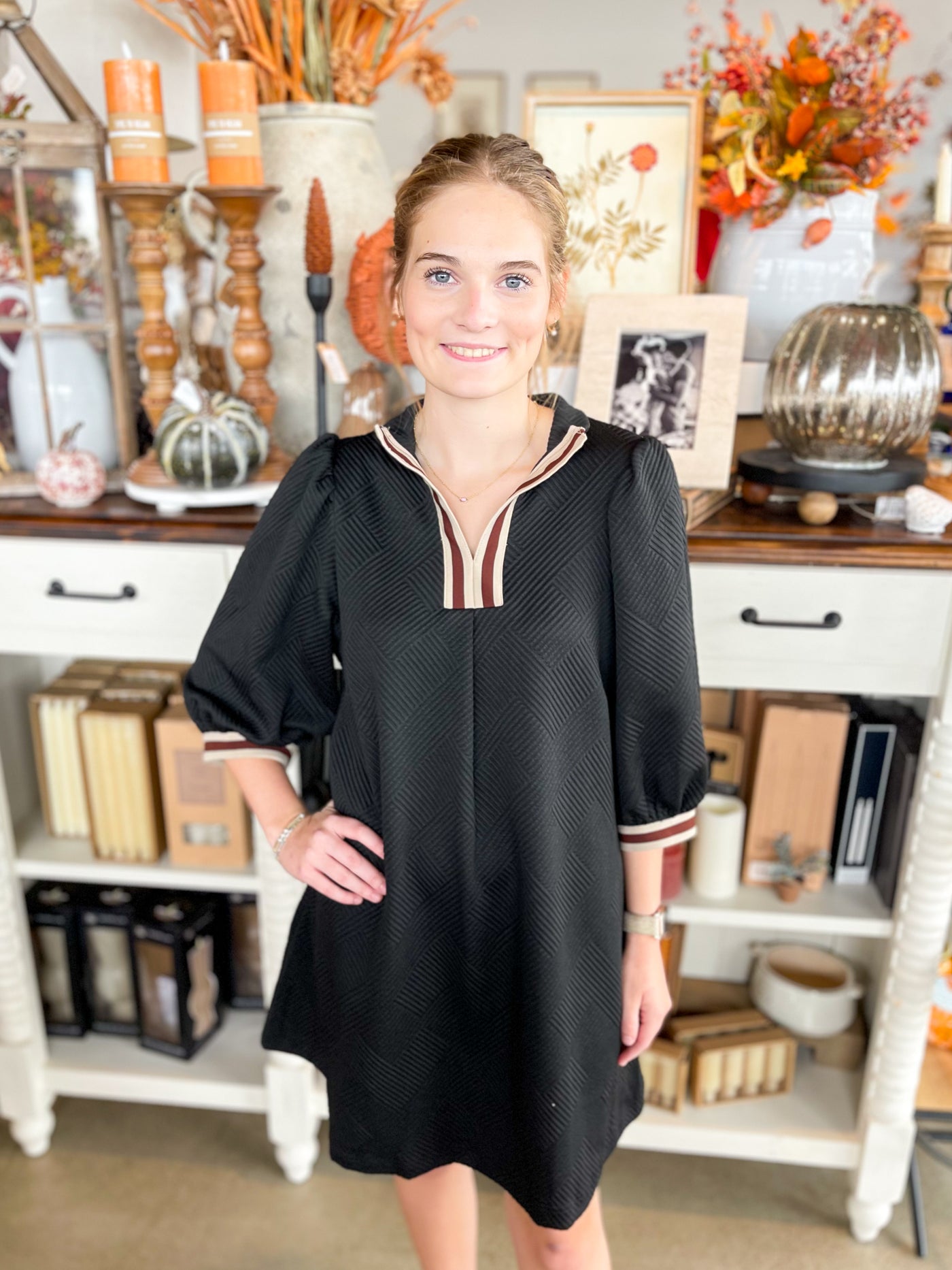 textured black short dress with color block lining of cream and brown along the neckline and the hem of sleeves