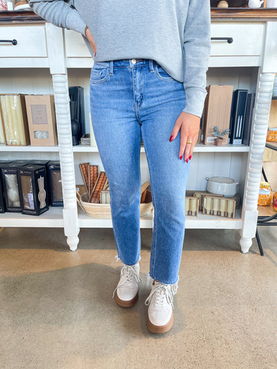 medium wash cropped slight flare jean with raw hem 